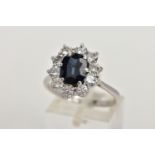 AN 18CT WHITE GOLD, SAPPHIRE AND DIAMOND CLUSTER RING, set with a cushion-shaped mixed-cut sapphire,