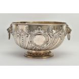 A VICTORIAN SILVER PUNCH BOWL, with cast lion mask and ring handles, the bowl repousse decorated