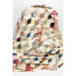 A HAND STITCHED PATCHWORK QUILT, the geometric design incorporating fabrics which appear to be