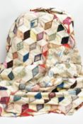 A HAND STITCHED PATCHWORK QUILT, the geometric design incorporating fabrics which appear to be