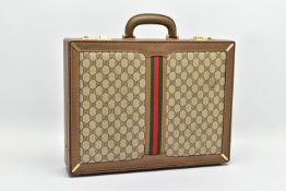 A VINTAGE GUCCI BRIEFCASE WITH GREEN LEATHER TRIM, the front and back vinyl panels with Gucci