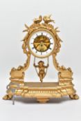 A LATE 19TH CENTURY GILT SPELTER CHERUB ON A SWING MANTEL CLOCK, the drum shaped clock surmounted by