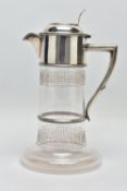 A LATE VICTORIAN SILVER MOUNTED GLASS CLARET JUG, the hinged cover with foliate pierced