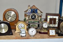 A COLLECTION OF ASSORTED CLOCKS AND BAROMETERS, including three oak cased mantel clocks, a battery
