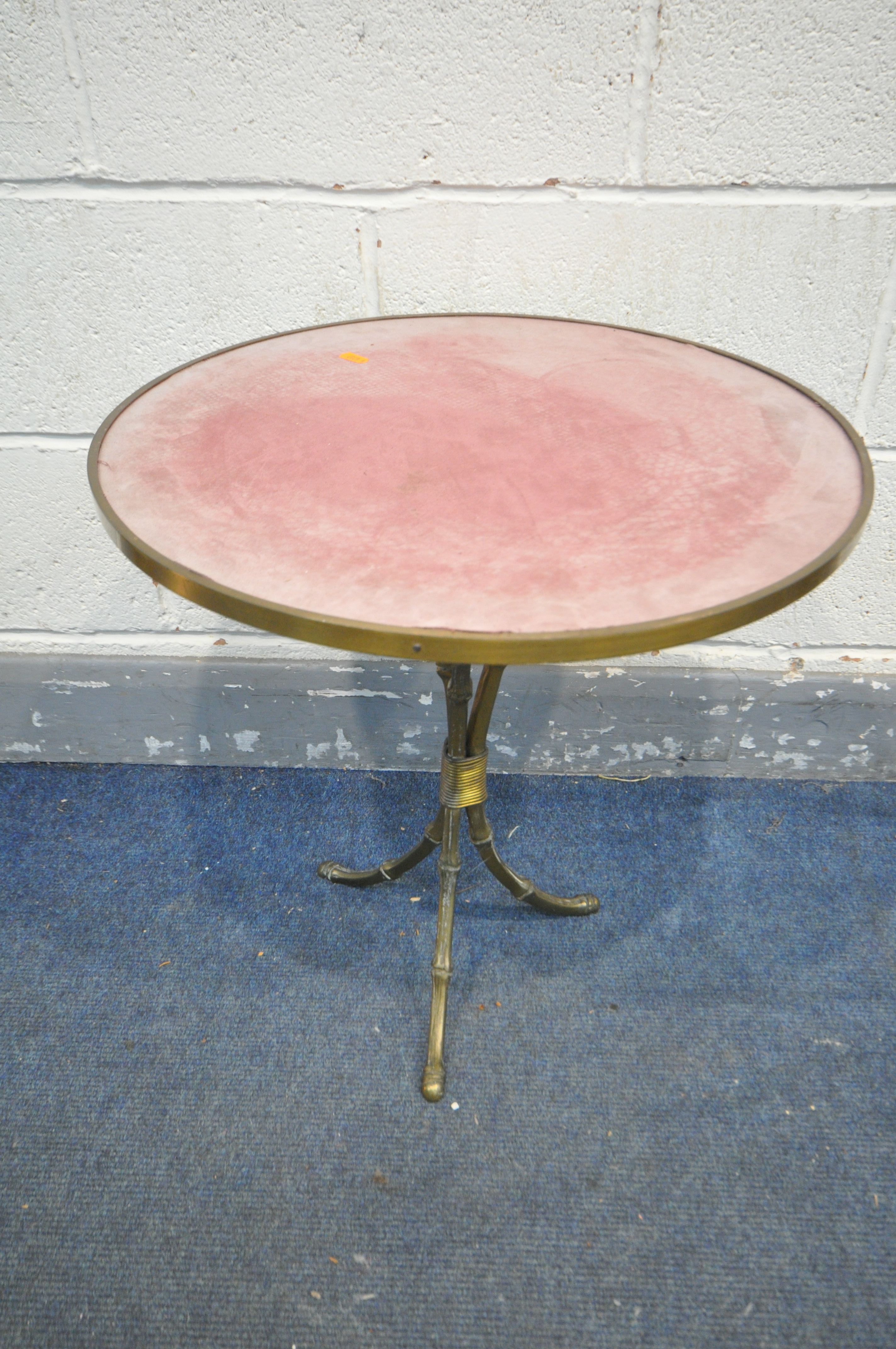 AN EARLY 20TH CENTURY BRASS CIRCULAR BAMBOO EFFECT SIDE TABLE, with a pink baize top surface,