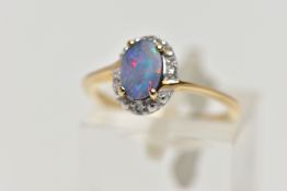 A 9CT GOLD OPAL DOUBLET RING, oval opal cabochon doublet, four claw set in yellow gold, within a