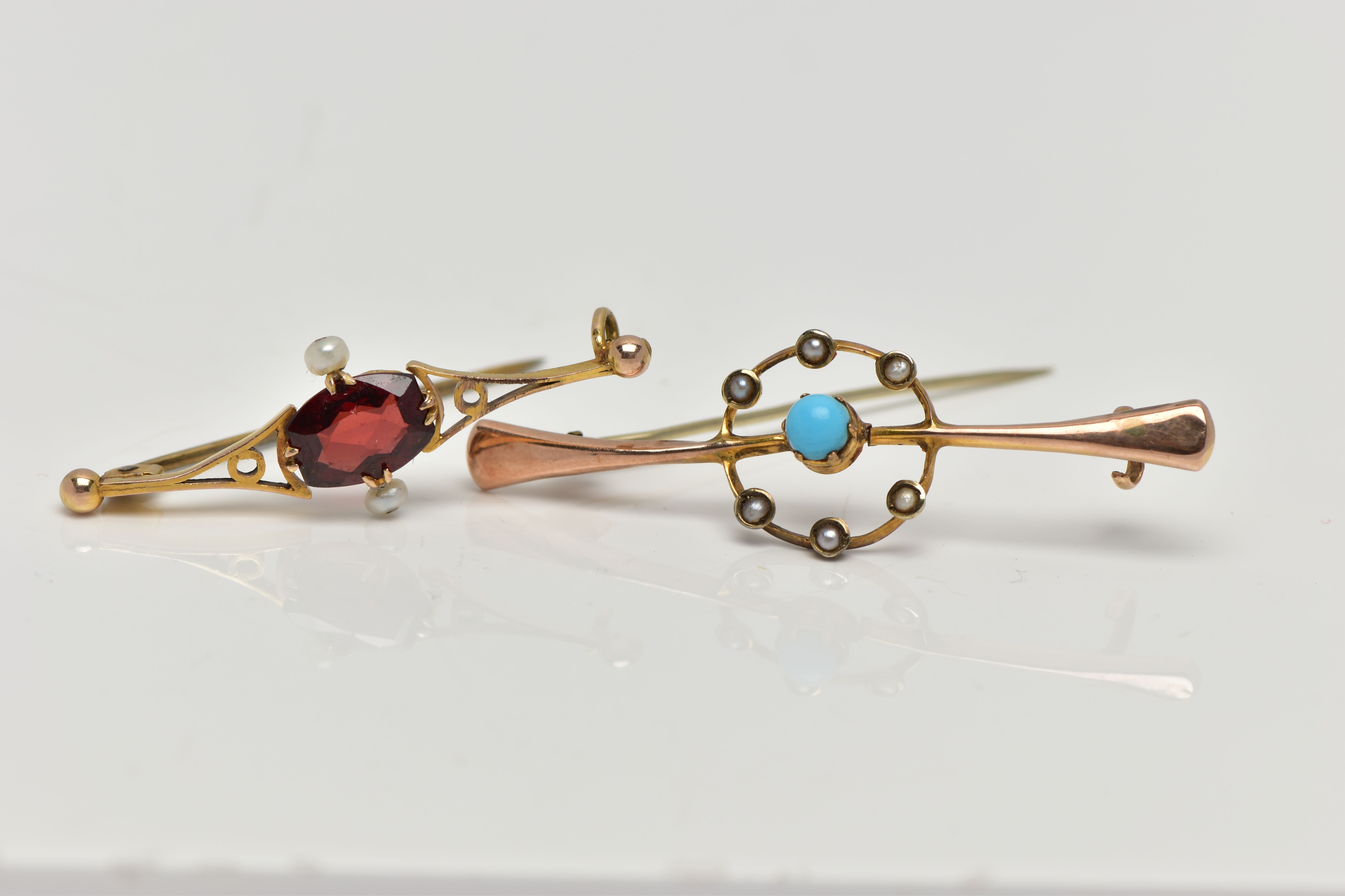 TWO YELLOW METAL BAR BROOCHES, the first set with a central turquoise cabochon, within an openwork