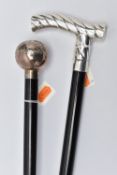 TWO SILVER HANDLED WALKING STICKS, the first a bulbous silver pommel detailed with a floral and