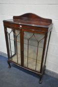 A MAHOGANY TWO DOOR DISPLAY CABINET, with a raised back, two glass shelves, on ball and claw feet,