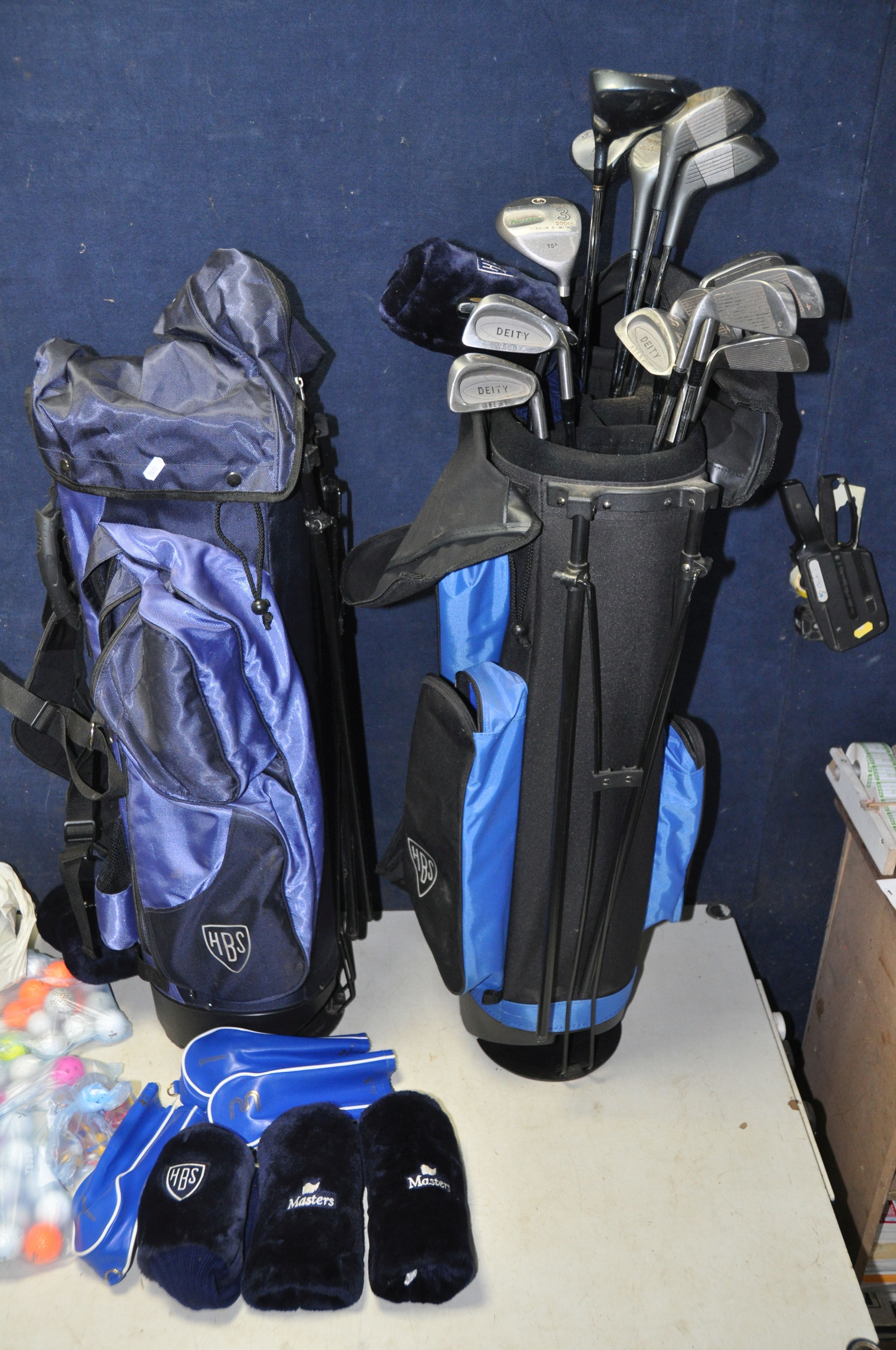 GOLF CLUBS AND ACCESSORIES to include a HBS golf bag containing a full set of deity clubs, two
