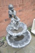 A HENRI STUDIO COMPOSITE WATER FOUNTAIN, made up of two tiers with a boy at the top sitting on a