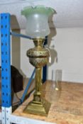 A VICTORIAN, BRASS BASED OIL LAMP, the acid etched clear and opaque, green, fluted shade above a