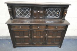 A PRIORY OAK COURT CUPBOARD, the raised back with two lead glazed doors, base with three drawers