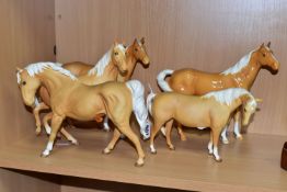 A GROUP OF FIVE BESWICK HORSES AND FOALS, in palomino matt and gloss glazes, comprising a Swish Tail
