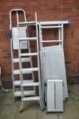 AN ALUMINIUM GARDEN LADDER with platform, along with an extension ladder, step ladders and a folding