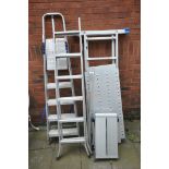 AN ALUMINIUM GARDEN LADDER with platform, along with an extension ladder, step ladders and a folding