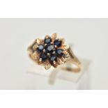 A 9CT GOLD SAPPHIRE CLUSTER RING, designed as a floral cluster set with seven circular cut