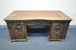 A FRENCH OAK KNEE HOLE DESK, with a leatherette writing surface, single drawer flanked by two