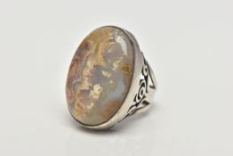 A WHITE METAL AGATE SINGLE STONE RING, the oval cut banded agate cabochon, collet set with