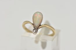 A YELLOW METAL OPAL AND DIAMOND RING, milgrain collet mounted pear shape opal cabochon and a