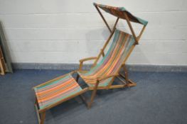 A VINTAGE STRIPPED DECK CHAIR, with canopy and footrest