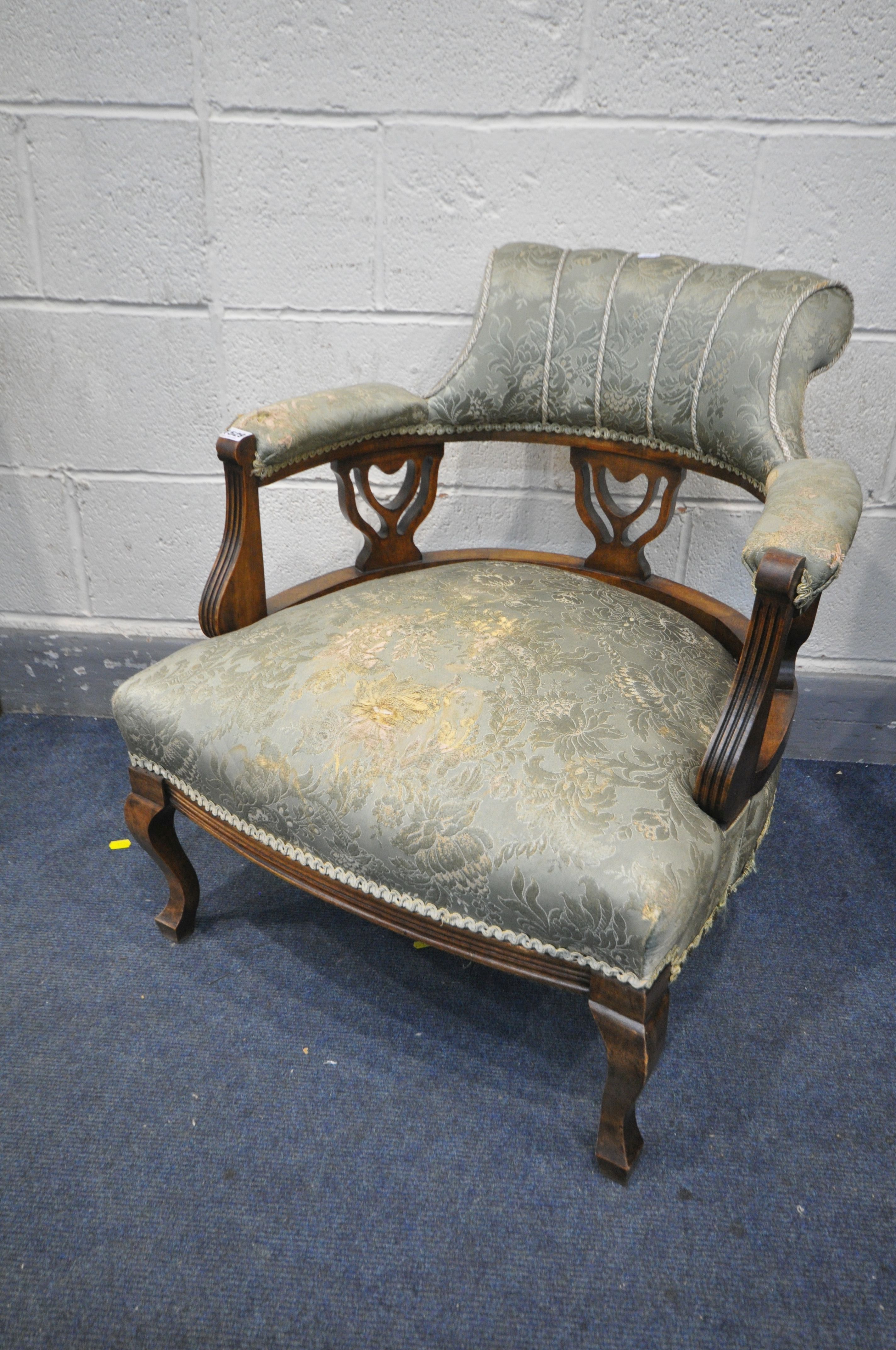 AN EDWARDIAN MAHOGANY TUB CHAIR, with scrolled back (condition - tears to both arms)