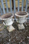 A PAIR OF CAST IRON CAMPAGNA GARDEN URNS, with twin handles, diameter 46cm x height 65cm (