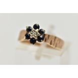 A 1970S 9CT GOLD SAPPHIRE AND DIAMOND CLUSTER RING, AF, the single cut diamond, within a surround of