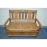 A STAINED TEAK STORAGE BENCH, length 121cm (condition:-lid warping to each end, weathered)