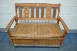 A STAINED TEAK STORAGE BENCH, length 121cm (condition:-lid warping to each end, weathered)