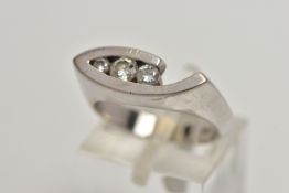 A WHITE METAL DIAMOND RING, the ring head of an abstract lozenge shape, set with three graduated