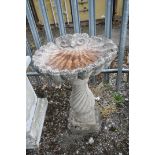 A COMPOSITE SHELL SHAPED BIRD BATH, on a separate spiralling base, diameter 52cm x height 80cm (