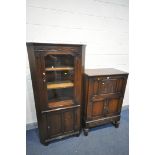 AN OAK DRINKS CABINET with mirrored interior, above double cupboard doors, and single drawer,