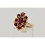 A 9CT GOLD GARNET CLUSTER RING, the central marquise cut garnet surrounded by eight circular cut