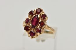 A 9CT GOLD GARNET CLUSTER RING, the central marquise cut garnet surrounded by eight circular cut