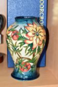 A BOXED MOORCROFT POTTERY 'SPIKE' BALUSTER VASE, having tube lined orange and yellow flowers with