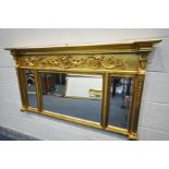 A REPRODUCTION REGENCY STYLE GILT FRAMED MIRROR, with triple bevelled edge plates, width 140cm x
