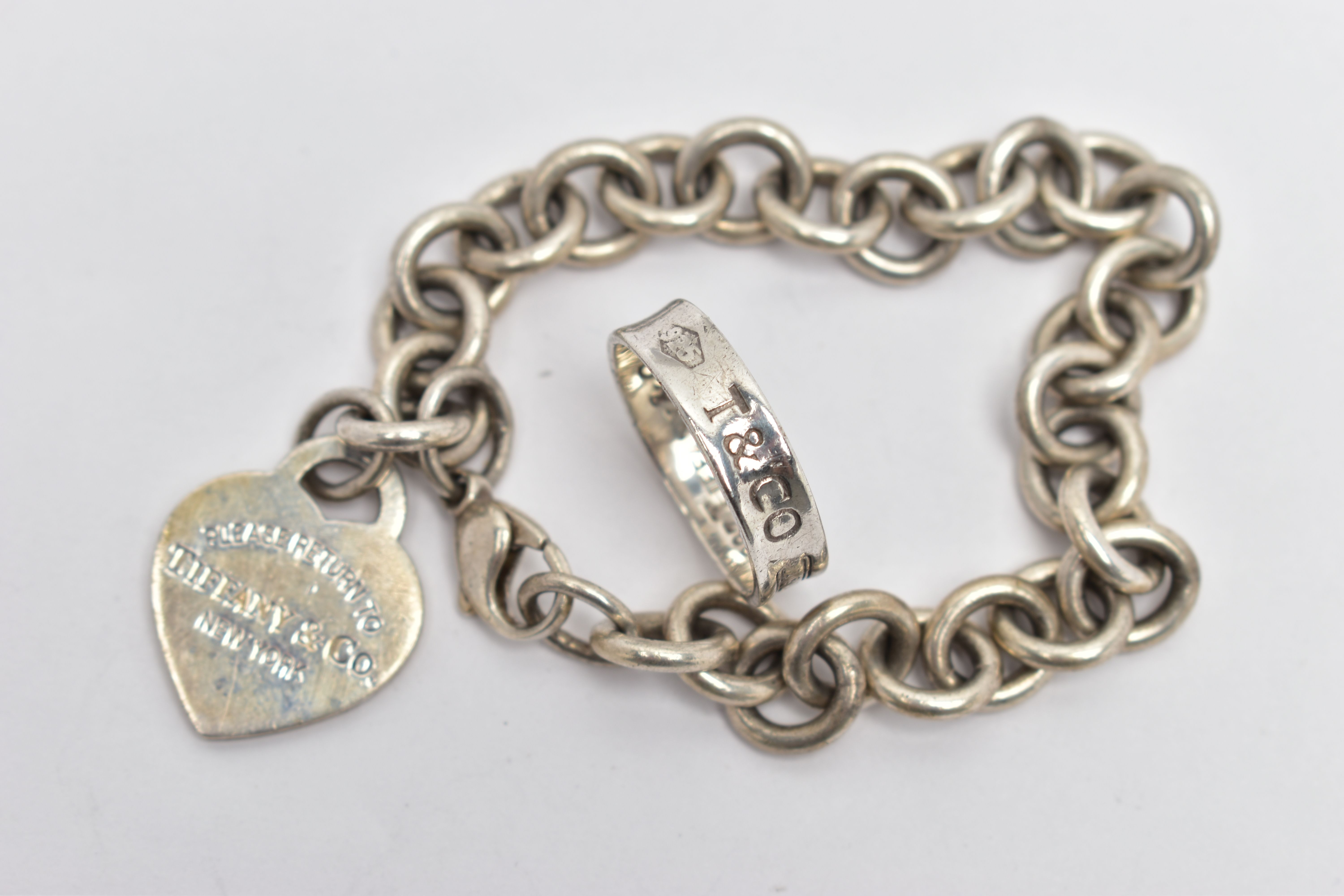 A SILVER 'RETURN TO TIFFANY & CO.' BRACELET AND WHITE METAL T&CO. '1837' RING, the curb link