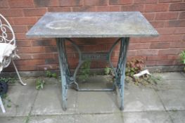 A MARBLE TOP TABLE, on a singer treadle sewing machine base, width 81cm x depth 48cm x height 73cm