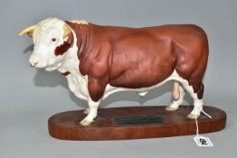 A BESWICK HEREFORD BULL FIGURE, no A2542A, matt glaze, on an oval wooden plinth, from the