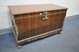 A BRAZILIAN WALNUT SERPENTINE BLANKET CHEST, with brass mounts and handles, and raising internal