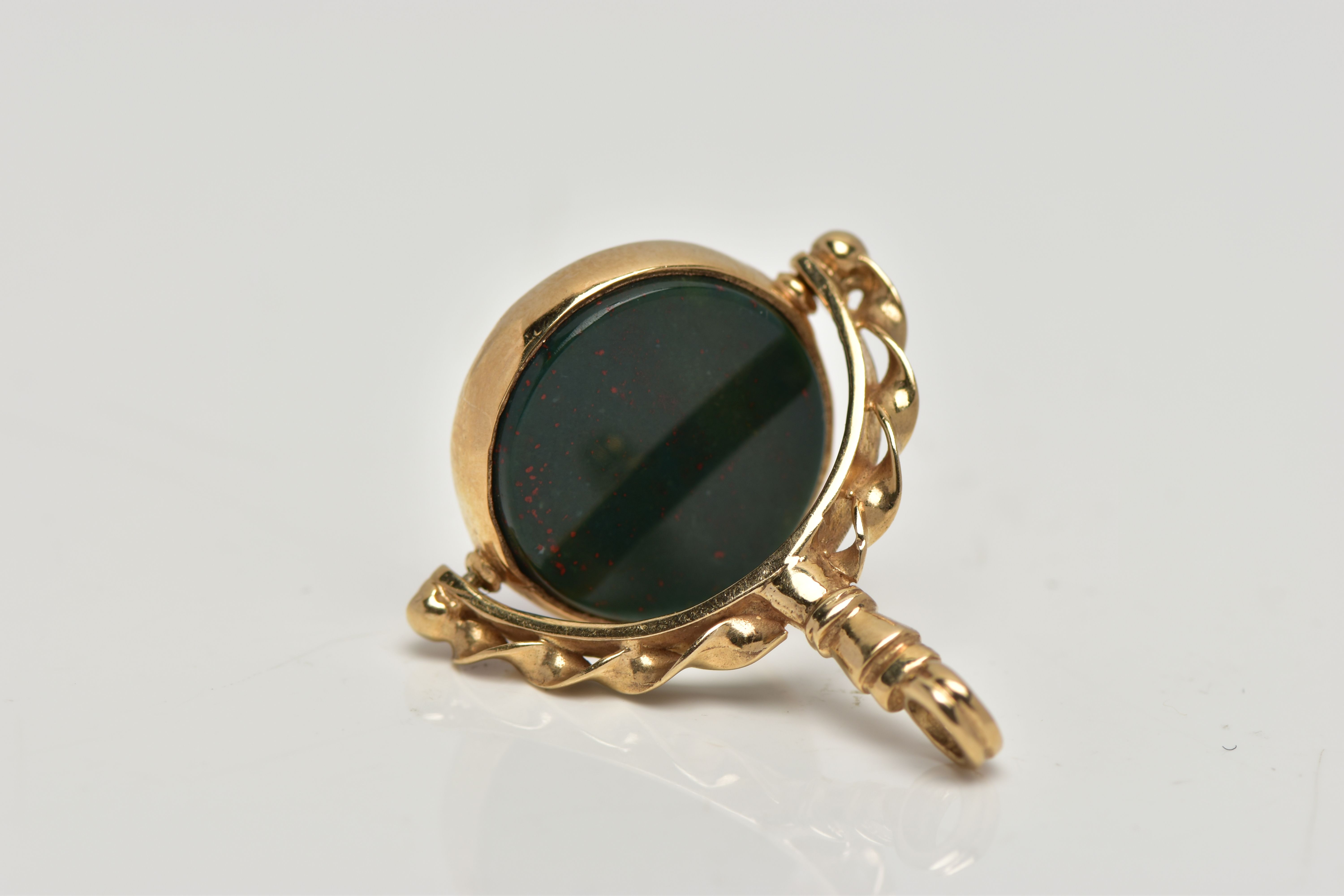 A 9CT GOLD HARDSTONE SWIVEL FOB, the bloodstone and carnelian circular panels, rotating to the