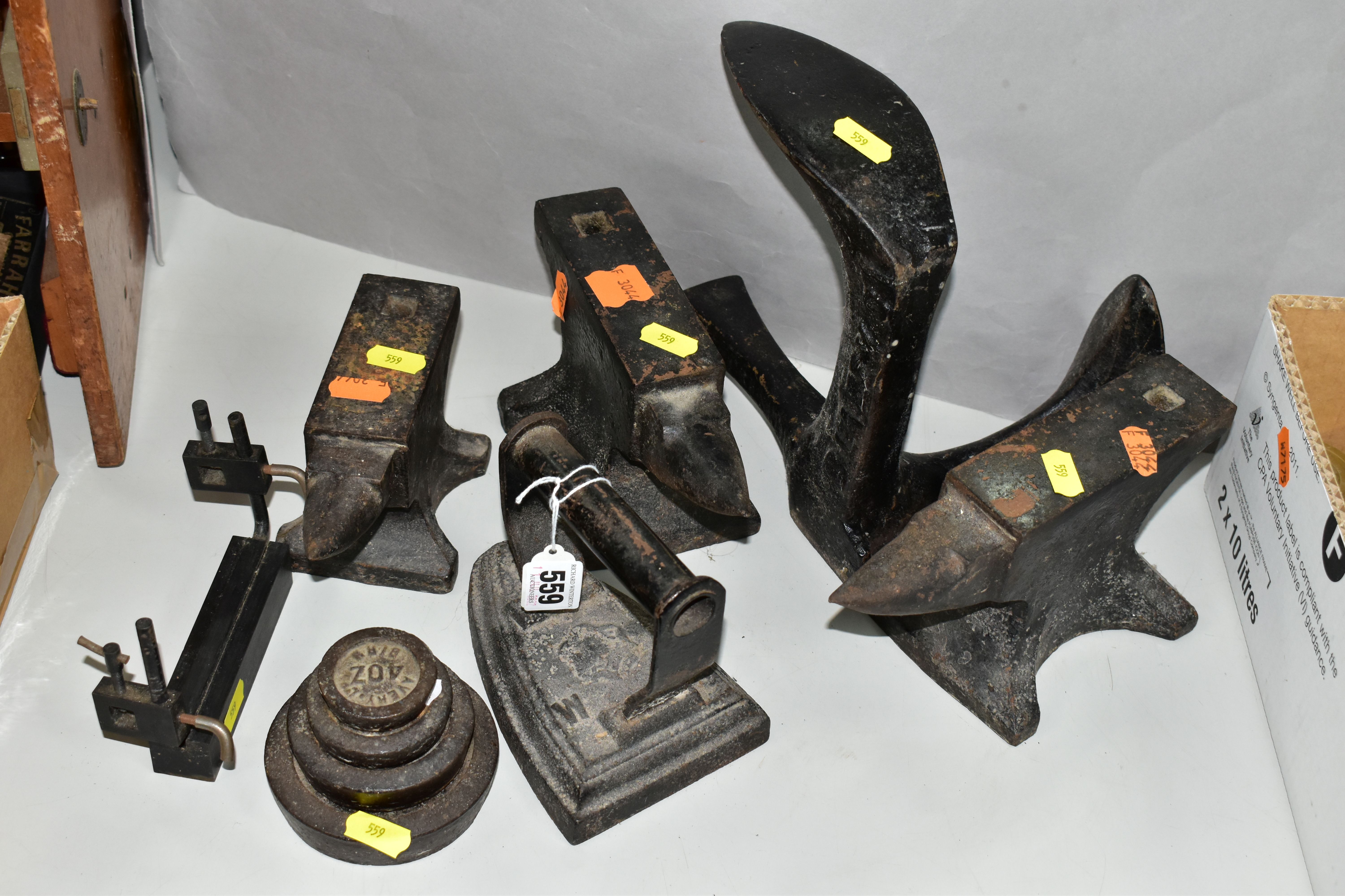 CAST IRON METALWARES ETC comprising three graduated bench top blacksmiths anvils, largest size