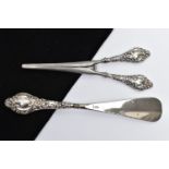 A SILVER HANDLED SHOEHORN AND GLOVE STRETCHERS, a matching set detailing a scrolling foliage design,
