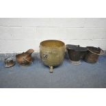A BRASS LOG BUCKET, with twin lion handles, and three claw feet, a copper log bucket, with two