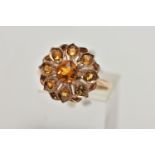 A 9CT GOLD CITRINE CLUSTER RING, flower cluster set with circular cut citrines, approximate