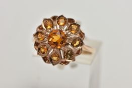 A 9CT GOLD CITRINE CLUSTER RING, flower cluster set with circular cut citrines, approximate