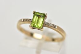 A 9CT GOLD PERIDOT AND DIAMOND DRESS RING, the rectangular shape peridot, within a claw setting,