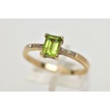 A 9CT GOLD PERIDOT AND DIAMOND DRESS RING, the rectangular shape peridot, within a claw setting,