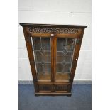 AN OLD CHARM OAK LEAD GLAZED TWO DOOR DISPLAY CABINET, with three internal shelves, and two small